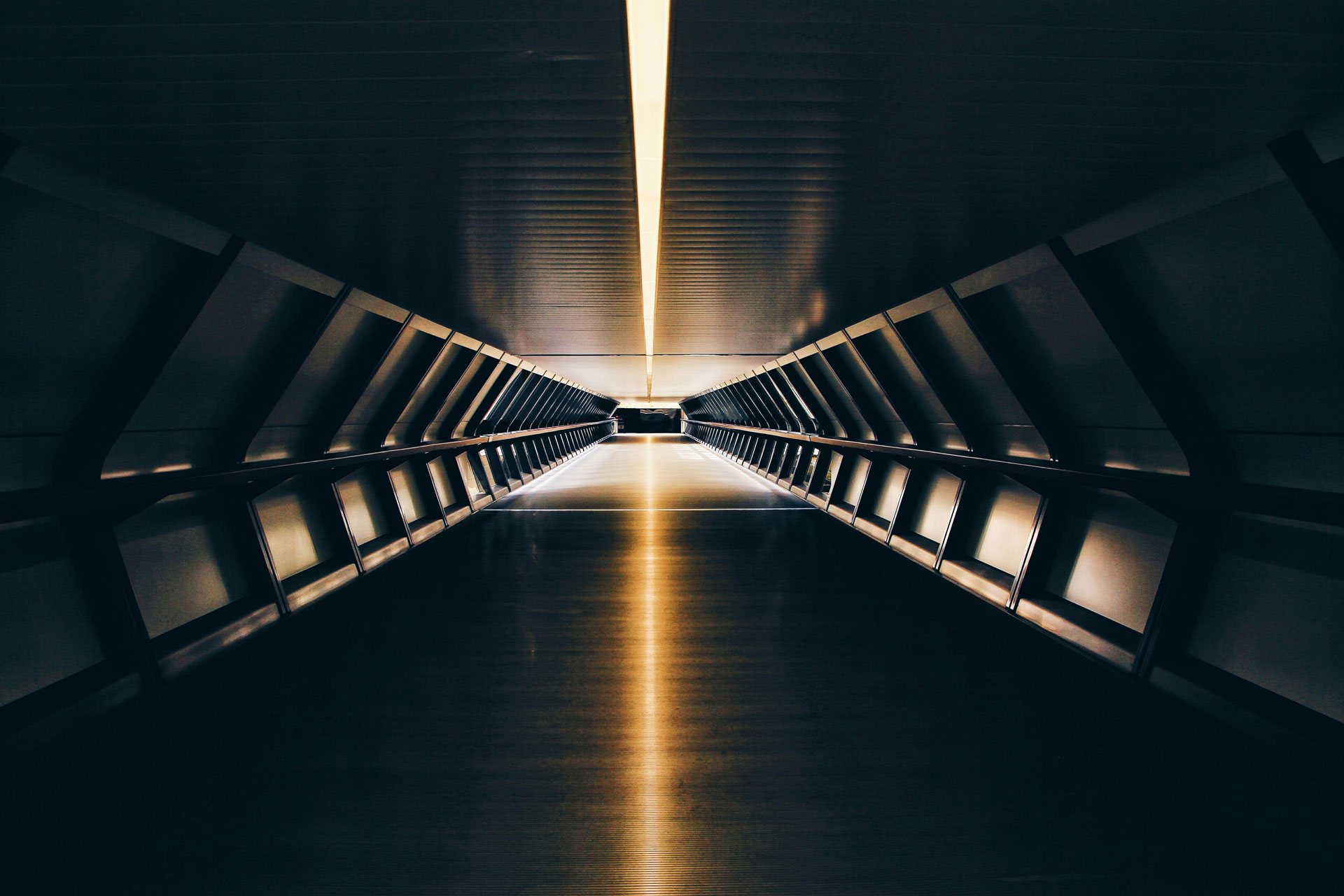 Long hallway with a golden light on the ceiling